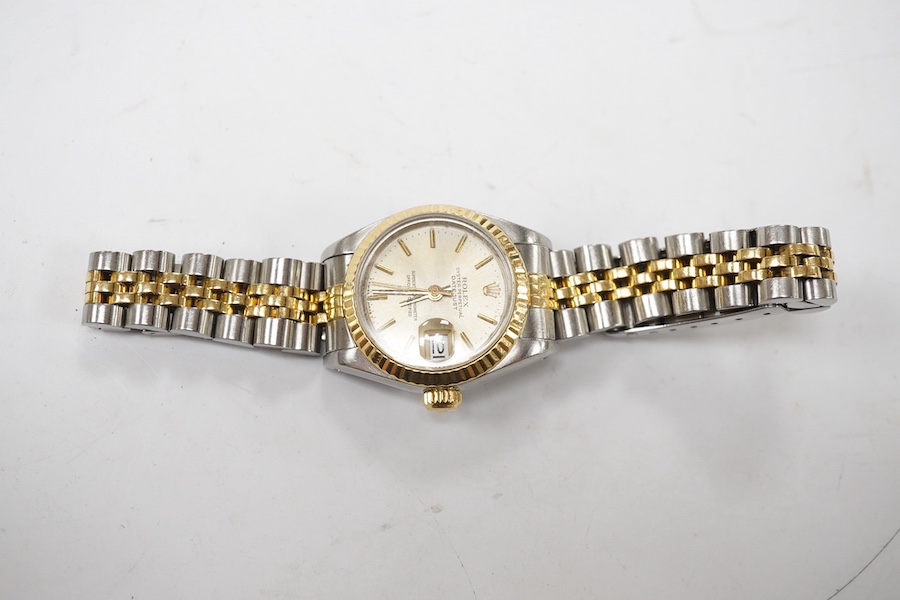 A lady's late 1980's steel and gold Rolex Oyster Perpetual Datejust wrist watch, with baton numerals, serial no. 9773085, on a steel and gold Rolex bracelet, no box or papers. Condition - poor to fair